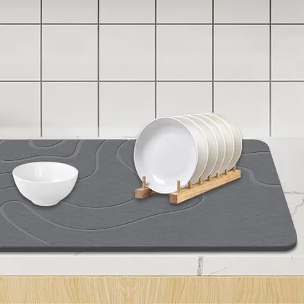 Grey ZIKIBL stone mat used as a dish-drying mat on a kitchen counter